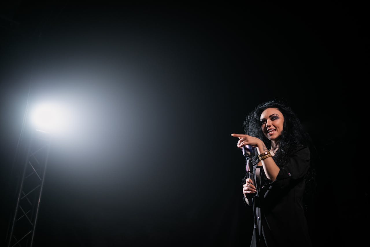 Crafting Captivating Headlines: Your awesome post title goes here Live performance of a female singer on stage under a spotlight, exuding energy and charisma.